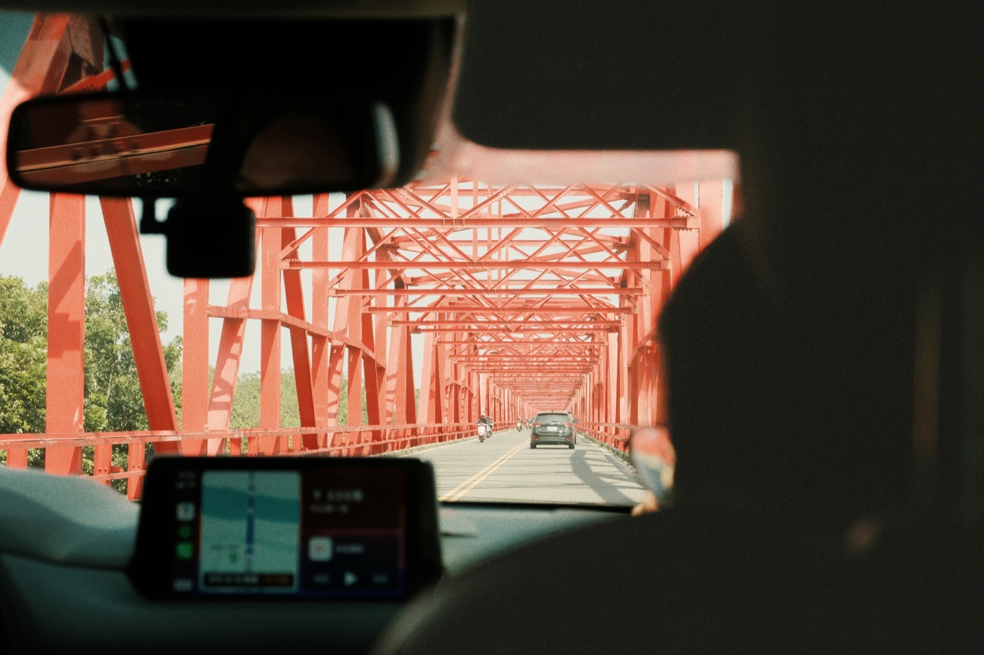 View through a truck windshield of the road ahead, with a dash camera mounted on the glass